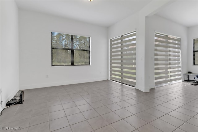 tiled empty room with a wealth of natural light