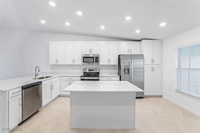 kitchen featuring stainless steel appliances, sink, light tile patterned floors, and vaulted ceiling