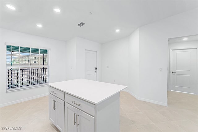 kitchen featuring a center island and light tile patterned flooring