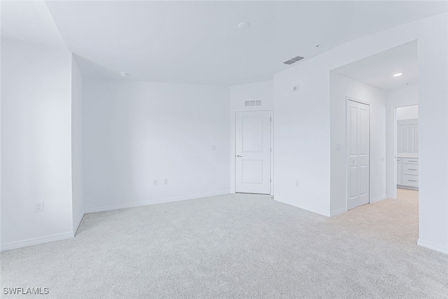 spare room with light colored carpet