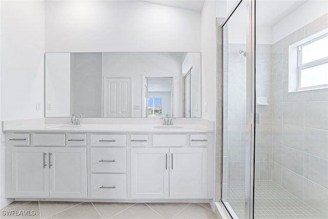 bathroom featuring vanity, tile patterned floors, and walk in shower