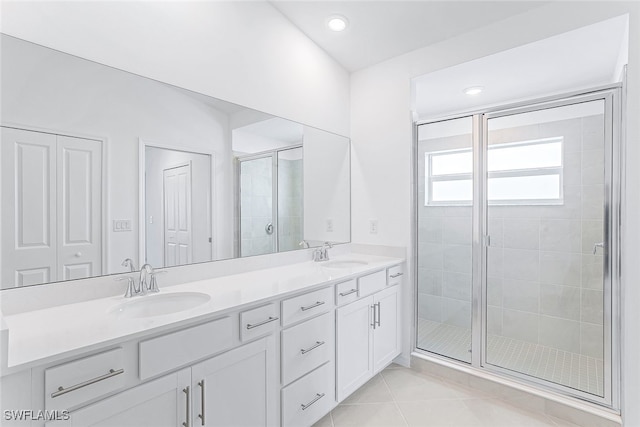 bathroom featuring vanity, walk in shower, and tile patterned flooring