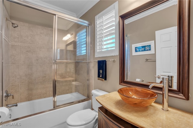 full bathroom with enclosed tub / shower combo, ornamental molding, vanity, and toilet