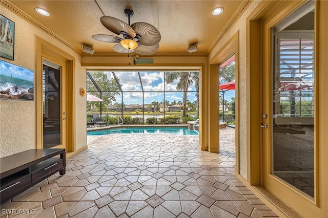 unfurnished sunroom with a swimming pool and ceiling fan