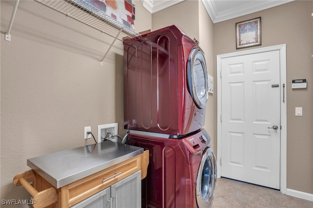 laundry room with crown molding, stacked washer and dryer, and light tile patterned floors