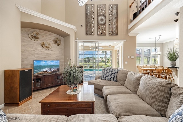 tiled living room with crown molding and a high ceiling