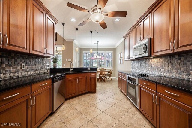 kitchen with hanging light fixtures, decorative backsplash, light tile patterned flooring, stainless steel appliances, and ornamental molding