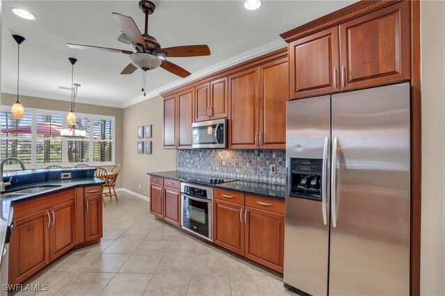 kitchen featuring sink, stainless steel appliances, decorative light fixtures, crown molding, and ceiling fan