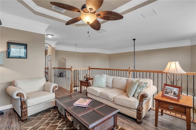 living room featuring ceiling fan, dark hardwood / wood-style floors, and ornamental molding