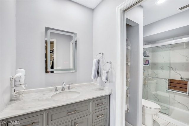 bathroom featuring vanity, toilet, and an enclosed shower