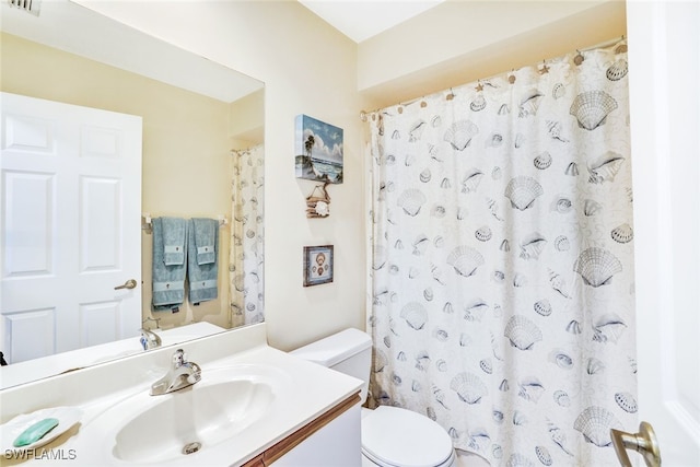 bathroom with walk in shower, vanity, and toilet