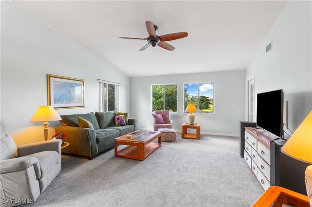 living room featuring high vaulted ceiling, ceiling fan, and light colored carpet