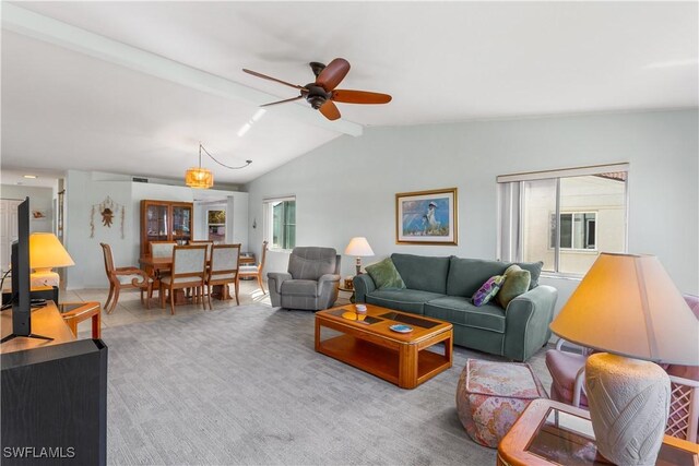 carpeted living room featuring vaulted ceiling and ceiling fan