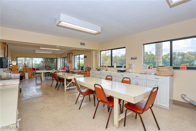 dining space with a textured ceiling