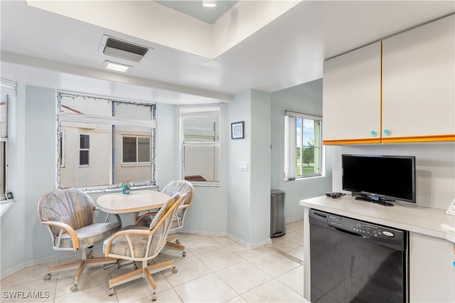 interior space with white cabinets, dishwasher, and light tile patterned floors