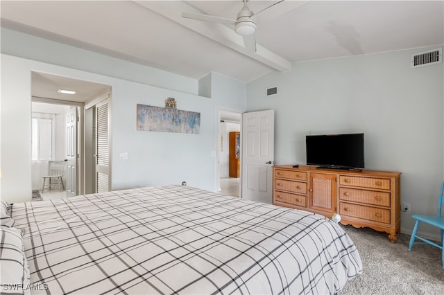 bedroom featuring vaulted ceiling with beams, ceiling fan, light colored carpet, and a closet