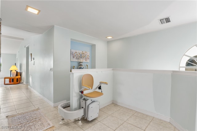 interior space featuring lofted ceiling and tile patterned flooring