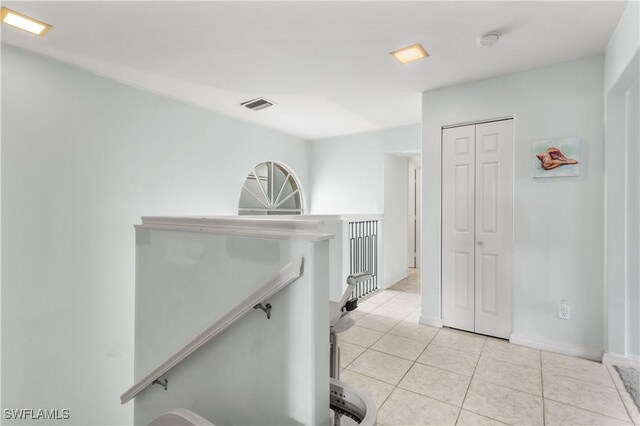 hallway featuring light tile patterned floors