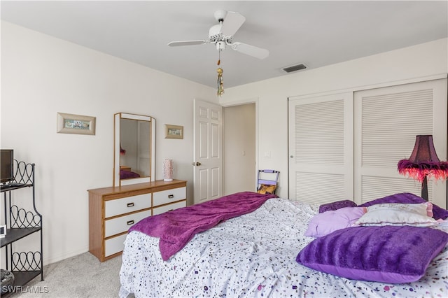 carpeted bedroom with a closet and ceiling fan