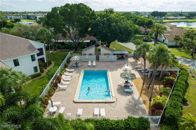 view of pool featuring a water view and a patio area