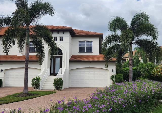 mediterranean / spanish home featuring a garage