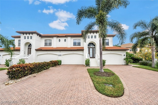 mediterranean / spanish-style home with a garage