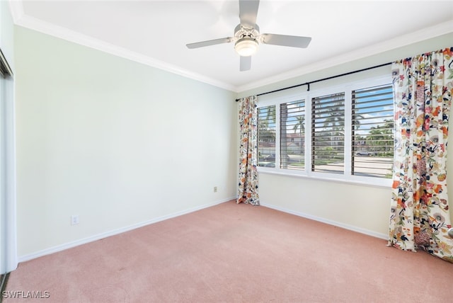 carpeted empty room with ceiling fan and ornamental molding