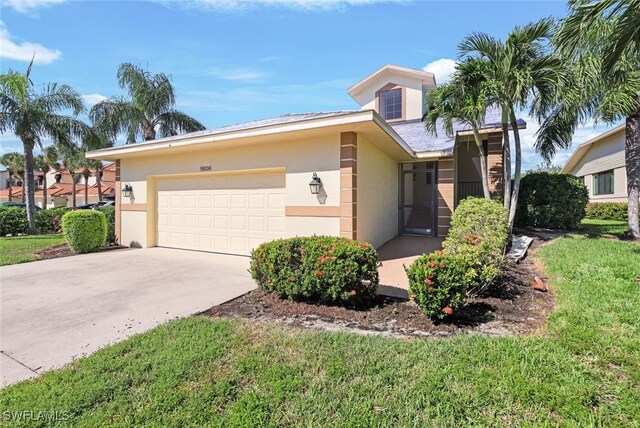 view of front of property featuring a garage and a front lawn