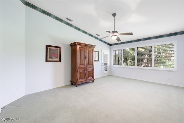 unfurnished bedroom with ceiling fan, light carpet, and lofted ceiling