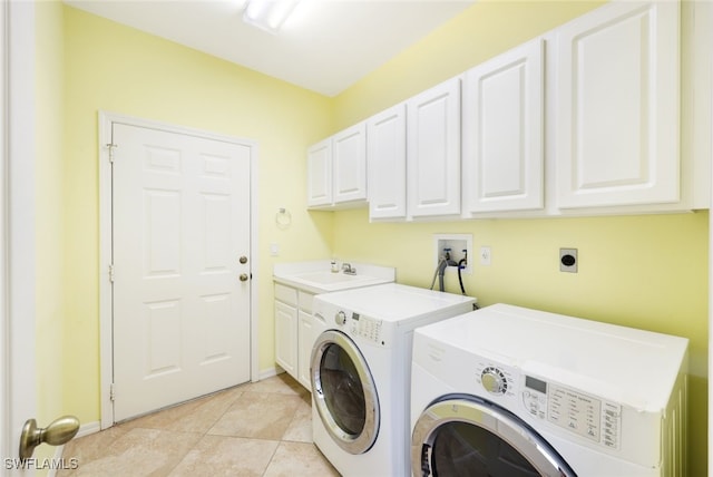 laundry room with sink, cabinets, washing machine and dryer, and light tile patterned floors