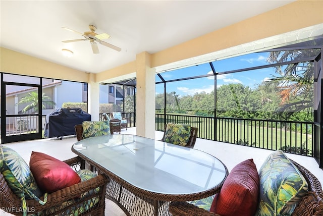 sunroom featuring a ceiling fan