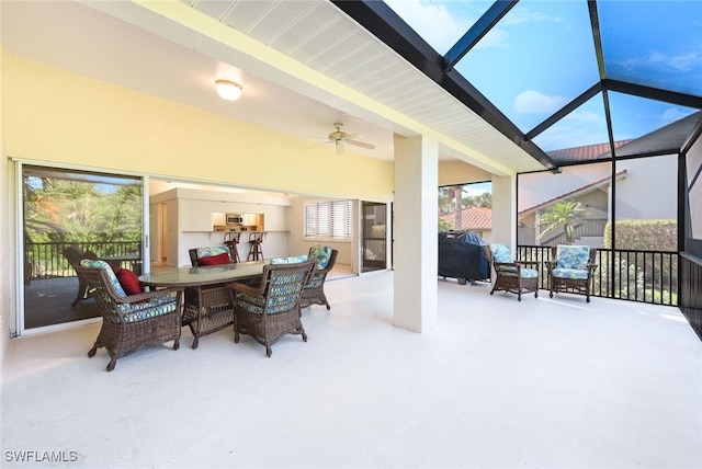 sunroom / solarium featuring a wealth of natural light and ceiling fan