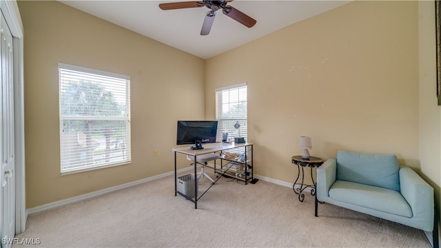 home office with lofted ceiling, carpet flooring, ceiling fan, and baseboards