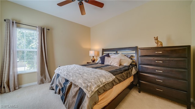 bedroom featuring lofted ceiling, ceiling fan, and light carpet