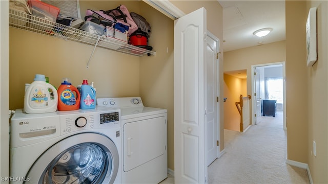 laundry area featuring baseboards, laundry area, washing machine and clothes dryer, and light colored carpet