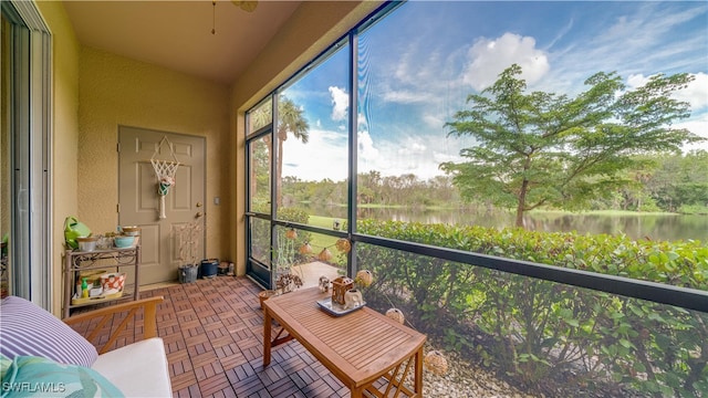 sunroom / solarium featuring a water view