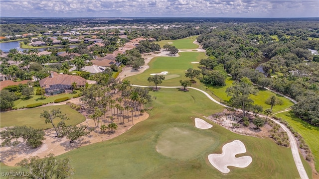 birds eye view of property featuring view of golf course and a water view