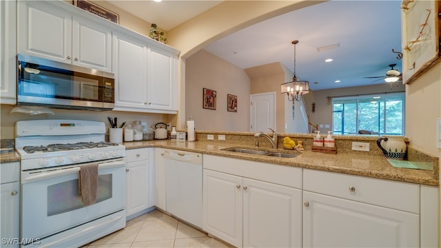 kitchen featuring ceiling fan with notable chandelier, white appliances, pendant lighting, sink, and white cabinetry