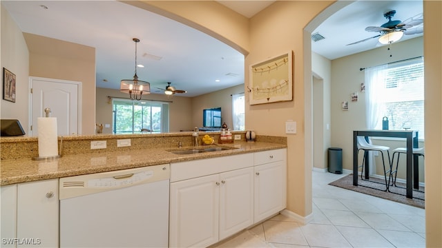 kitchen with light tile patterned floors, ceiling fan, white dishwasher, a sink, and visible vents