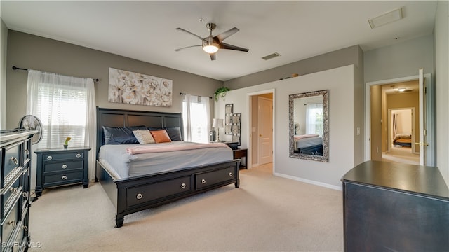 bedroom featuring light carpet, a ceiling fan, visible vents, and baseboards