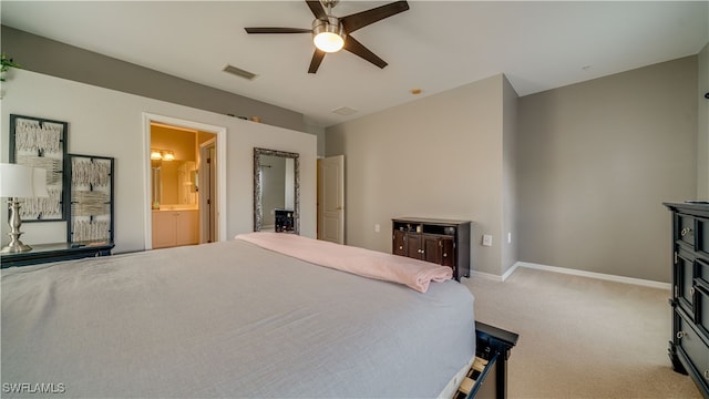 carpeted bedroom featuring ensuite bath and ceiling fan