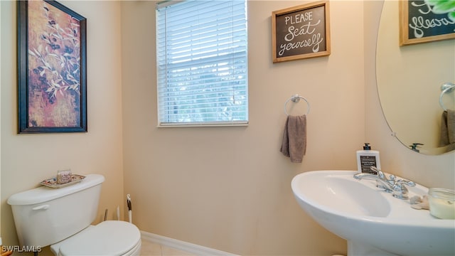 bathroom with a wealth of natural light, toilet, and sink