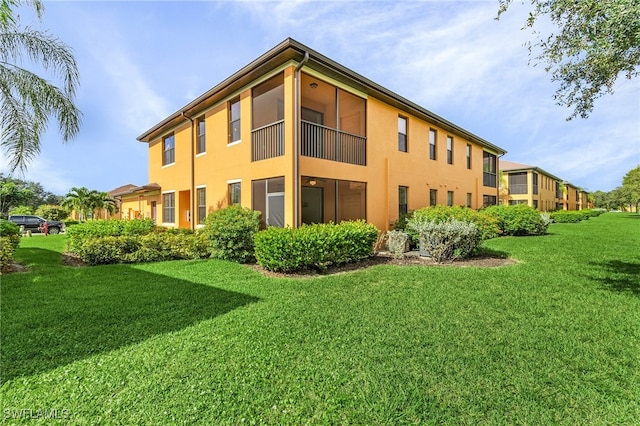 rear view of house featuring a yard