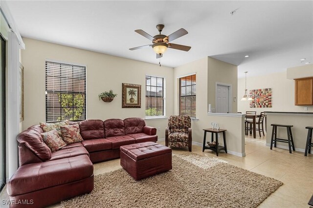 living room featuring ceiling fan and light tile patterned floors