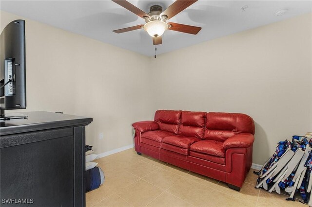 living room with ceiling fan and light tile patterned floors