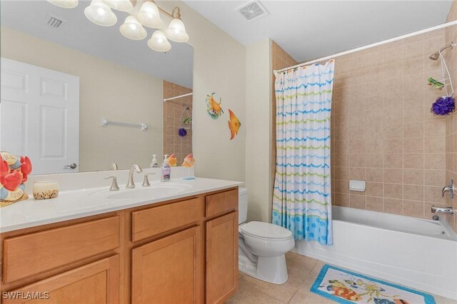 full bathroom with vanity, toilet, shower / bath combo with shower curtain, and tile patterned flooring