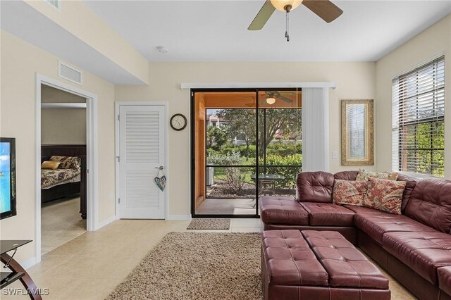 tiled living room with ceiling fan