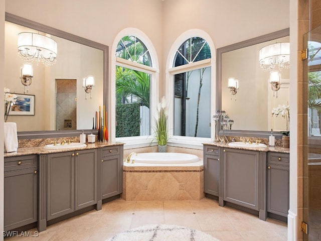 bathroom with vanity, a notable chandelier, and plus walk in shower