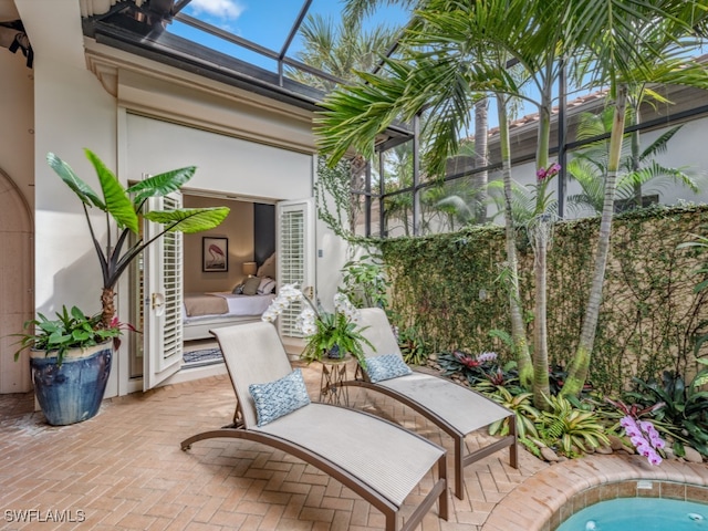 view of patio / terrace featuring glass enclosure