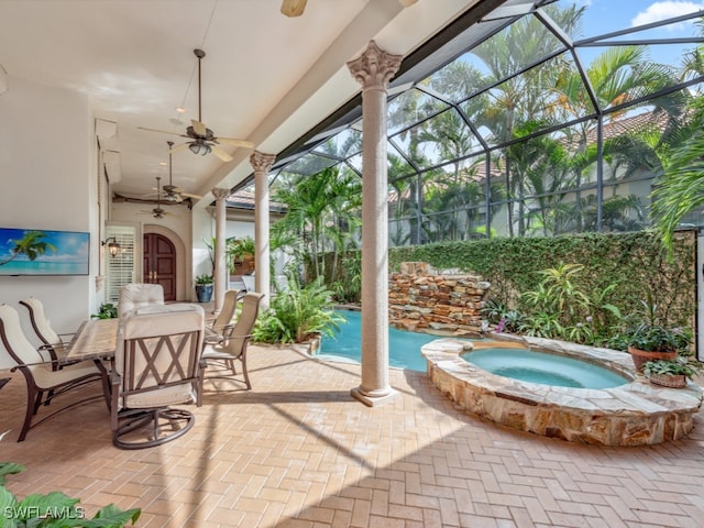 view of patio / terrace with ceiling fan, a lanai, and a swimming pool with hot tub